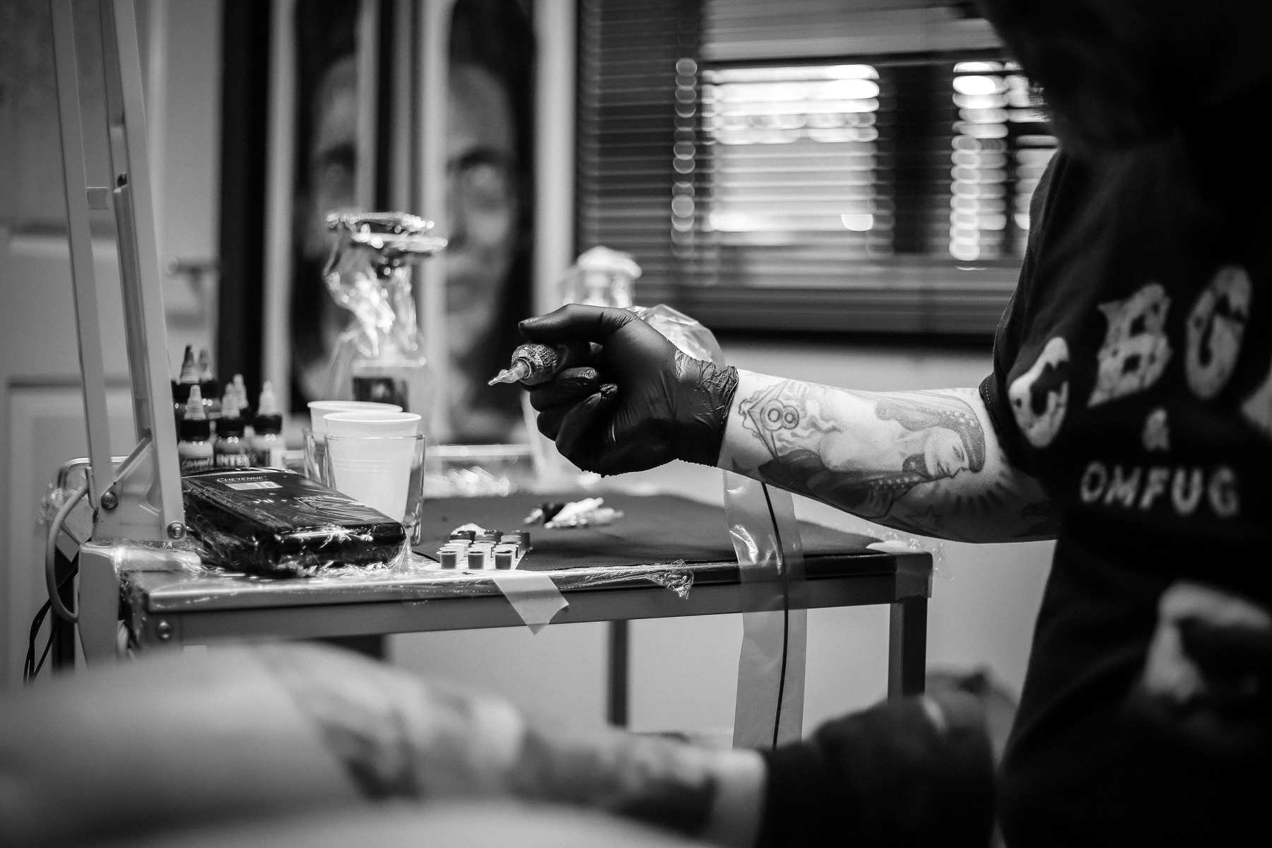 Tattoo artist preparing a tattoo machine inside a studio